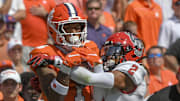 Sep 21, 2024; Clemson, South Carolina, USA; Clemson Tigers wide receiver T.J. Moore (1) catches a pass against North Carolina State Wolfpack cornerback Brandon Cisse (2) during the first quarter at Memorial Stadium. Mandatory Credit: Ken Ruinard-Imagn Images