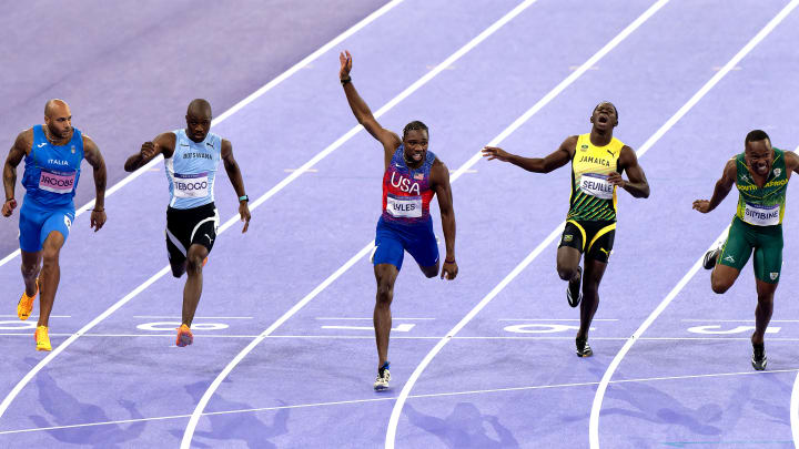 Noah Lyles (USA, center) wins the 100m race at Paris 2024