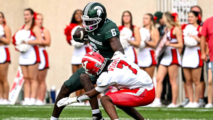 Michigan State's Nick Marsh, left, spins off a tackle attempt by Youngstown State's Justin Wimpye during the second quarter on Saturday, Sept. 13, 2025, at Spartan Stadium in East Lansing.
