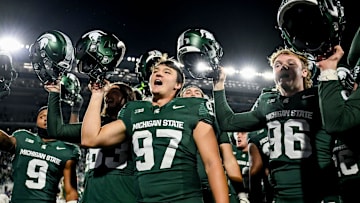 Michigan State's Jonathan Kim, center, celebrates with the team after the win over Iowa during the fourth quarter on Saturday, Oct. 19, 2024, at Spartan Stadium in East Lansing.