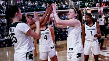 Michigan State's Julia Ayrault, right, slaps hands with teammates before the game against Oregon on Thursday, Jan. 30, 2025, at the Breslin Center in East Lansing.
