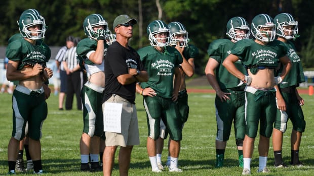 Head coach Rich Alercio and some members of the St. Johnsbury Academy football team watch the action during the scrimmage