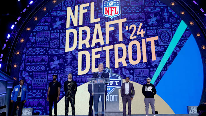 NFL commissioner Roger Goodell addresses the crowd with Eminem and the Detroit Lions' Jared Goff, Amon-Ra St. Brown and Aidan Hutchinson, and Hall of Famers Calvin Johnson and Barry Sanders on the stage before Round 1 of the NFL draft on April 25, 2024, in Detroit.