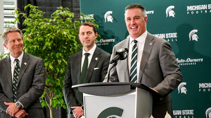 Michigan State's new football coach Pat Fitzgerald talks during his introductory press conference on Tuesday, Dec. 2, 2025, at the Tom Izzo Football Building in East Lansing. MSU athletic director J Batt, center, and MSU president Kevin Guskiewicz, left, look on.
