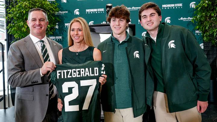 Michigan State's new football coach Pat Fitzgerald, left, and his family pose for a photo after his introductory press conference on Tuesday, Dec. 2, 2025, at the Tom Izzo Football Building in East Lansing.