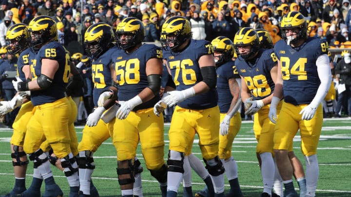 The Michigan Wolverines offensive line, including Zak Zinter (65), Olusegun Oluwatimi (55), Giovanni El-Hadi (58) and Ryan Hayes (76), and tight ends Matthew Hibner (88) and Joel Honigford, get set against the Illinois Fighting Illini at Michigan Stadium on Nov. 19, 2022.

Michill 111922 Kd 2348