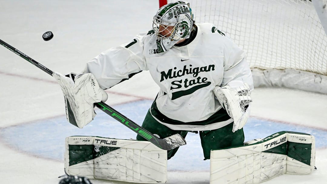 Michigan State's Trey Augustine deflects a Minnesota shot during overtime on Saturday, Jan. 25, 2025, at Munn Arena in East Lansing.