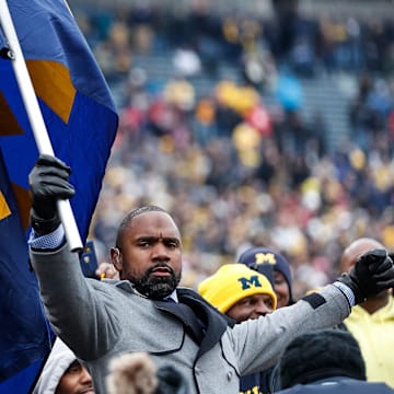 Charles Woodson waves a Michigan flag among fans before the Ohio State game at the Michigan Stadium in Ann Arbor, Saturday, Nov. 30, 2019.