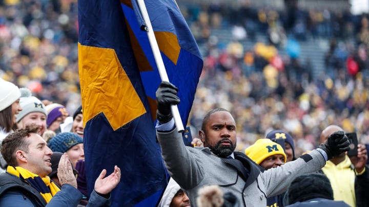 Charles Woodson waves a Michigan flag among fans before the Ohio State game at the Michigan Stadium in Ann Arbor, Saturday, Nov. 30, 2019.