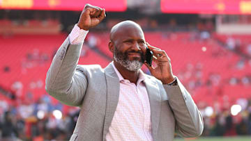 Detroit Lions general manager Brad Holmes shows appreciation for fans as he walk onto the field
