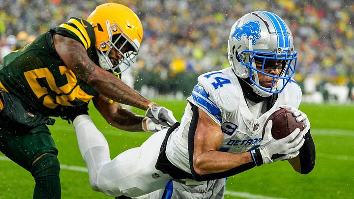Detroit Lions wide receiver Amon-Ra St. Brown (14) makes a catch for a touchdown against Green Bay Packers cornerback Keisean Nixon (25) during the first half at Lambeau Field in Green Bay, Wis. on Sunday, Nov. 3, 2024.