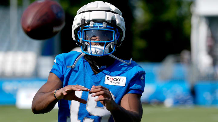 Detroit Lions wide receiver Donovan Peoples-Jones catches footballs from the JUGS machine after practice at the Detroit Lions practice facility in Allen Park on Friday, July 26, 2024