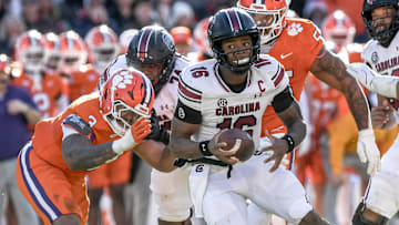 Nov 30, 2024; Clemson, South Carolina, USA; South Carolina quarterback LaNorris Sellers (16) runs away from Clemson defensive end T.J. Parker (3) during the fourth quarter at Memorial Stadium. Mandatory Credit: Ken Ruinard-Imagn Images