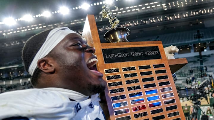 Penn State's Anthony Donkoh carried the Land Grant Trophy back to the locker room after the game against Michigan State on Saturday, Nov. 15, 2025, at Spartan Stadium in East Lansing.