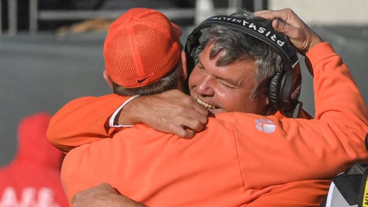 Clemson offensive line coach Matt Luke, right, hugs Head Coach Dabo Swinney during the fourth quarter of the TaxSlayer Gator Bowl at EverBank Stadium in Jacksonville , Florida, Friday, December 29, 2023. Clemson won 38-35.