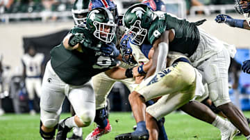 Michigan State's Jalen Thompson, right, tackles Florida Atlantic's Cam Fancher during the fourth quarter on Friday, Aug. 30, 2024, at Spartan Stadium in East Lansing.