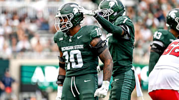 Michigan State's Wayne Matthews III, left, celebrates with Nikai Martinez after a tackle against Youngstown State during the third quarter on Saturday, Sept. 13, 2025, at Spartan Stadium in East Lansing.
