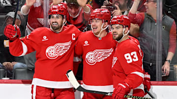 Mar 29, 2025; Detroit, Michigan, USA; Detroit Red Wings left wing Lucas Raymond (23) celebrates with Detroit Red Wings center Dylan Larkin (71) and Detroit Red Wings right wing Alex DeBrincat (93) after scoring a power play goal against the Boston Bruins in the second period at Little Caesars Arena. Mandatory Credit: Lon Horwedel-Imagn Images