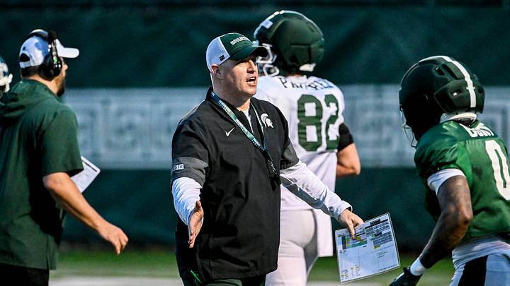 Michigan State's head coach Pat Fitzgerald, left, slaps hands with NiJhay Burt during spring football practice on Tuesday, April 14, 2026, in East Lansing.