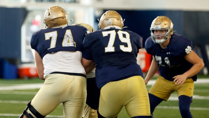 Notre Dame offensive linemen Billy Schrauth (74) and Tosh Baker (79) work on a blocking drill during practice Tuesday, Dec. 19, 2023, at the Irish Athletics Center in South Bend.