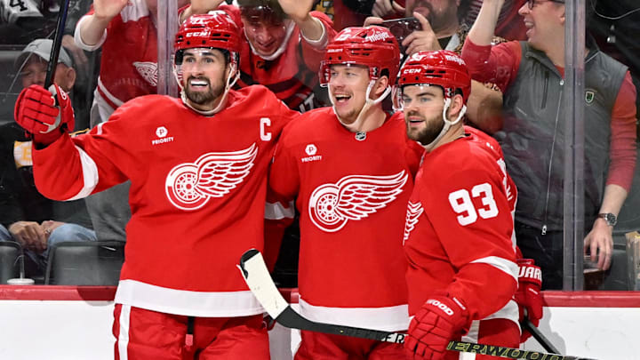 Mar 29, 2025; Detroit, Michigan, USA; Detroit Red Wings left wing Lucas Raymond (23) celebrates with Detroit Red Wings center Dylan Larkin (71) and Detroit Red Wings right wing Alex DeBrincat (93) after scoring a power play goal against the Boston Bruins in the second period at Little Caesars Arena. Mandatory Credit: Lon Horwedel-Imagn Images