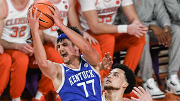 Dec 3, 2024; Clemson, South Carolina, USA; Kentucky guard Kerr Kriisa (77) rebounds near Clemson guard Chase Hunter (1) during the first half at Littlejohn Coliseum. Mandatory Credit: Ken Ruinard-Imagn Images