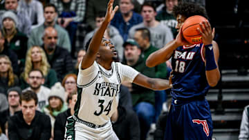 Michigan State's Xavier Booker, left, guards Florida Atlantic's Baba Miller during the first half on Saturday, Dec. 21, 2024, in East Lansing.