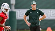 Michigan State's offensive coordinator Brian Lindgren works with the quarterbacks during the first day of football camp on Tuesday, July 30, 2024, in East Lansing.