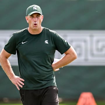Michigan State's offensive coordinator Brian Lindgren works with the quarterbacks during the first day of football camp on Tuesday, July 30, 2024, in East Lansing.