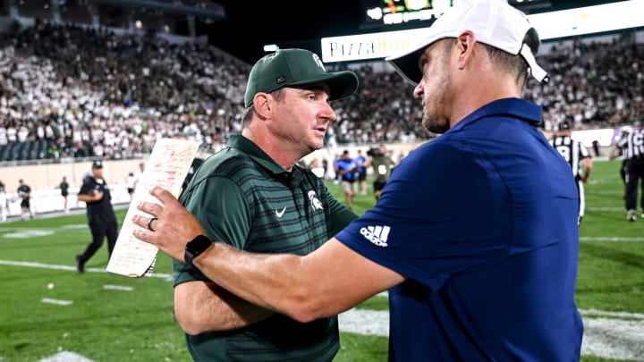 Michigan State's head coach Jonathan Smith, left shakes hands with Florida Atlantic's head coach Tom Herman after the game on Friday, Aug. 30, 2024, at Spartan Stadium in East Lansing.