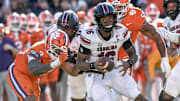 Nov 30, 2024; Clemson, South Carolina, USA; South Carolina quarterback LaNorris Sellers (16) runs away from Clemson defensive end T.J. Parker (3) during the fourth quarter at Memorial Stadium. Mandatory Credit: Ken Ruinard-Imagn Images
