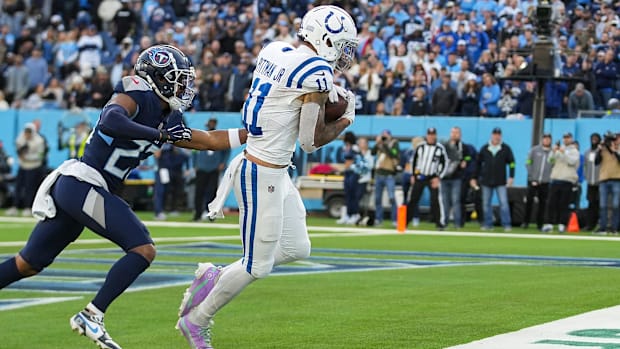 Colts receiver Michael Pittman Jr. (all-white uniform; blue trim) makes a touchdown reception against a division rival. 