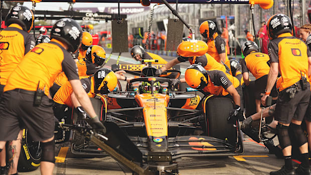 The McLaren F1 pit crew performs a pit stop on Lando Norris's car during the second practice at the Australian Grand Prix.