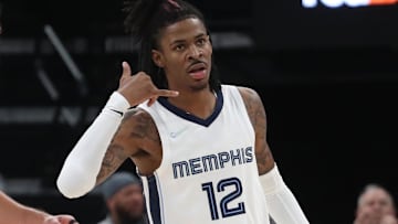 Nov 1, 2021; Memphis, Tennessee, USA; Memphis Grizzles guard Ja Morant (12) makes a phone gesture after a made basket during the second half against the Denver Nuggets  at FedExForum. Mandatory Credit: Petre Thomas-Imagn Images