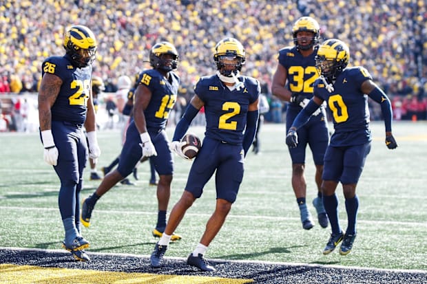 Michigan defensive back Will Johnson celebrates after intercepting a pass from Ohio State quarterback Kyle McCord.