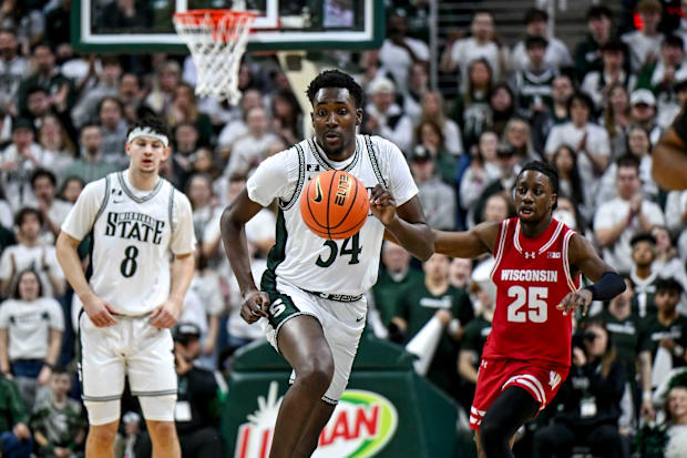 Michigan State's Xavier Booker moves the ball against Wisconsin.