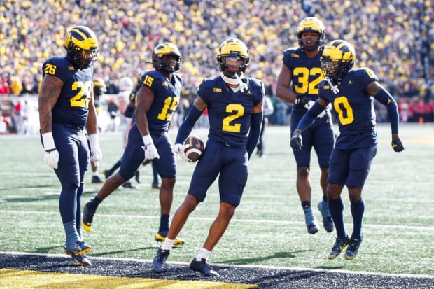 Michigan defense celebrates Will Johnson's interception during the Ohio State game in 2023