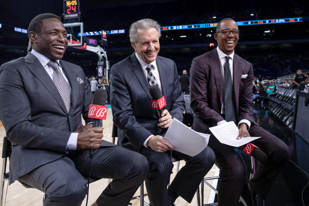 Former San Antonio Spurs players Sean Elliott and Avery Johnson sit alongside Bill Land prior to a broadcast.