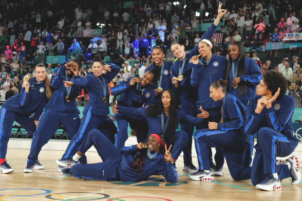 The Team USA women's basketball team poses with their gold medals at the Paris Olympics. 