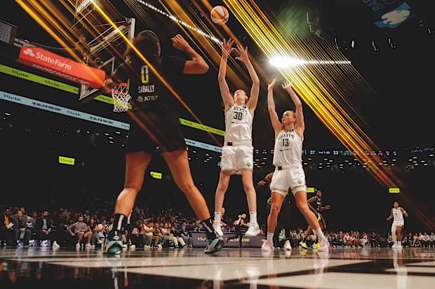 New York Liberty players Breanna Stewart and Leonie Fiebich try to block a pass. 