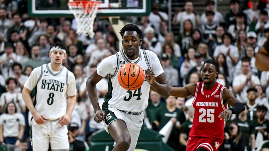 Michigan State's Xavier Booker moves the ball against Wisconsin.