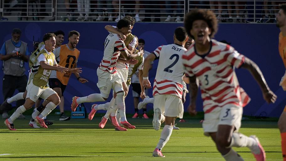 USMNT players celebrating wildly.