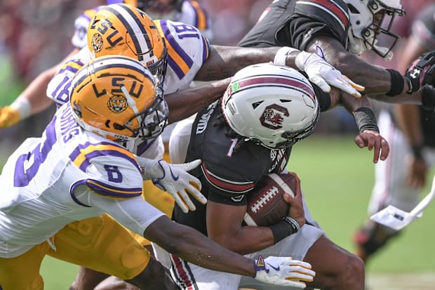 LSU safety Major Burns (8) and linebacker Greg Penn III (18) sack South Carolina quarterback Robby Ashford.