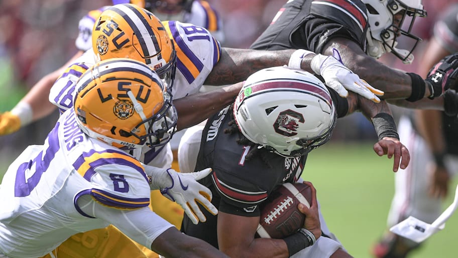 LSU safety Major Burns (8) and linebacker Greg Penn III (18) sack South Carolina quarterback Robby Ashford.