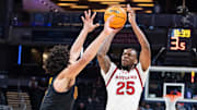 Mar 12, 2025; Indianapolis, IN, USA;  Rutgers Scarlet Knights guard Jeremiah Williams (25) shoots the ball while USC Trojans guard Desmond Claude (1) defends in the second half at Gainbridge Fieldhouse. Mandatory Credit: Trevor Ruszkowski-Imagn Images
