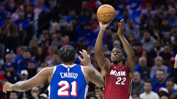 Apr 17, 2024; Philadelphia, Pennsylvania, USA; Miami Heat forward Jimmy Butler (22) shoots past Philadelphia 76ers center Joel Embiid (21) during the second quarter of a play-in game of the 2024 NBA playoffs at Wells Fargo Center. Mandatory Credit: Bill Streicher-USA TODAY Sports