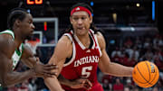 Indiana Hoosiers forward Malik Reneau (5) drives Thursday, March 13, 2025, against Oregon Ducks forward Supreme Cook (7) during the 2025 TIAA Big Ten Men’s Basketball Tournament at Gainbridge Fieldhouse in Indianapolis.