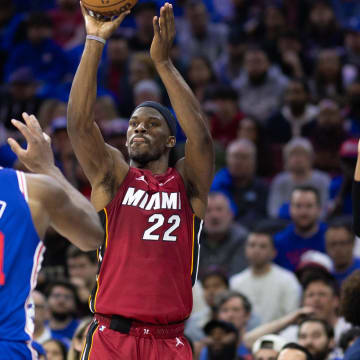 Apr 17, 2024; Philadelphia, Pennsylvania, USA; Miami Heat forward Jimmy Butler (22) shoots past Philadelphia 76ers center Joel Embiid (21) during the second quarter of a play-in game of the 2024 NBA playoffs at Wells Fargo Center. Mandatory Credit: Bill Streicher-USA TODAY Sports