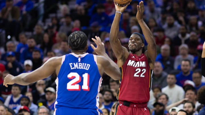 Apr 17, 2024; Philadelphia, Pennsylvania, USA; Miami Heat forward Jimmy Butler (22) shoots past Philadelphia 76ers center Joel Embiid (21) during the second quarter of a play-in game of the 2024 NBA playoffs at Wells Fargo Center. Mandatory Credit: Bill Streicher-USA TODAY Sports