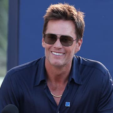 Aug 8, 2025; Foxborough, Massachusetts, USA; Retired New England Patriot Hall of Famer Tom Brady speaks during a statue unveiling before a game against the Washington Commanders at Gillette Stadium. Mandatory Credit: Paul Rutherford-Imagn Images